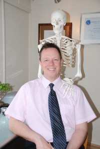 Jon McSwiney of Castle Osteopath Jon and hand on shoulder portrait 14th April 08